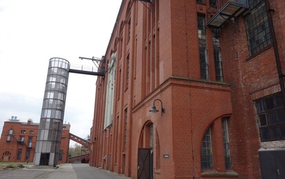 Die Energiefabrik von Außen. Ziegelsteingebäude mit einem hohen Treppenaufgang.